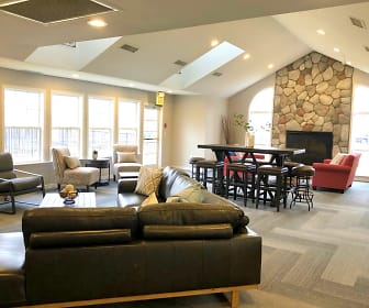 living room featuring a healthy amount of sunlight, vaulted ceiling with skylight, and a fireplace, Fairfield Apartment Homes