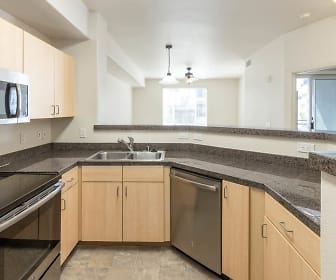 kitchen with natural light, stainless steel appliances, electric range oven, light tile floors, pendant lighting, light brown cabinets, and dark stone countertops, Archstone Fremont Center