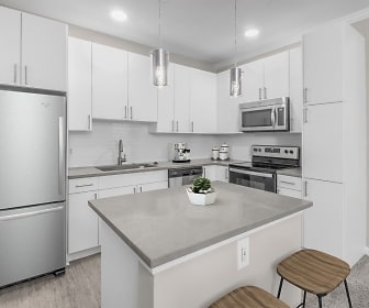 kitchen with a center island, carpet, a kitchen bar, stainless steel appliances, electric range oven, white cabinetry, light floors, pendant lighting, and light countertops, Camden South End