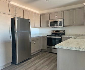 kitchen with stainless steel appliances, electric range oven, granite-like countertops, light brown cabinets, and light hardwood floors, Pleasant Drive Estates