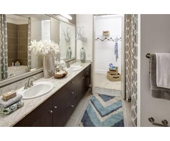 bathroom featuring tile flooring, shower curtain, mirror, and vanity, Arpeggio at Victory Park