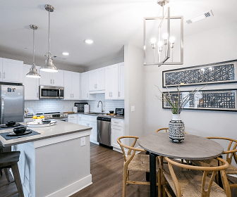 kitchen with a center island, stainless steel appliances, range oven, white cabinetry, pendant lighting, and dark floors, The Mark at Chatham Apartments