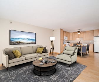 hardwood floored living room featuring a ceiling fan and refrigerator, Maple Ridge Apartment Homes