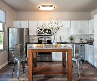 kitchen with a notable chandelier, natural light, stainless steel appliances, range oven, light countertops, white cabinetry, and dark floors, Venu At Galleria