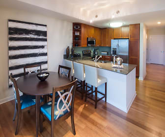 dining room featuring parquet floors, a kitchen breakfast bar, stainless steel refrigerator, range oven, and microwave, The Tower on Piedmont