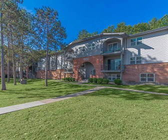 tudor-style house featuring an expansive front lawn, London Square and Blue Spruce Apts