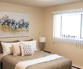 carpeted bedroom featuring natural light and baseboard radiator, The Lakes