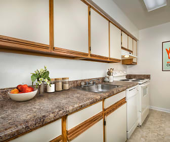 kitchen featuring electric range oven, exhaust hood, dishwasher, dark countertops, white cabinets, and light tile floors, Seneca Club