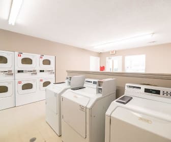 clothes washing area with tile floors, natural light, and separate washer and dryer, The Village at Brierfield