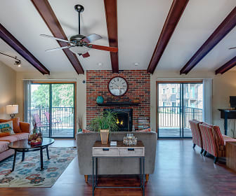 hardwood floored living room featuring a wealth of natural light, a ceiling fan, a brick fireplace, vaulted ceiling with beams, and TV, Westchester Square