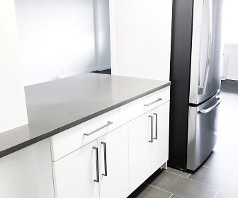 kitchen featuring stainless steel refrigerator, dark countertops, white cabinets, and light tile floors, Harbor View Tower