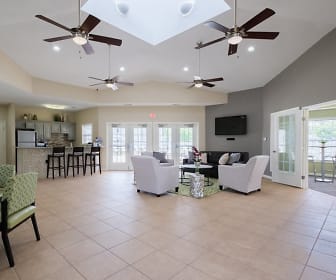 living room featuring a kitchen bar, a ceiling fan, vaulted ceiling, tile floors, refrigerator, and TV, Arbor Trails