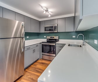 kitchen with electric range oven, stainless steel appliances, light countertops, light hardwood floors, and white cabinetry, Evanston Place Apartments