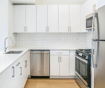 kitchen featuring stainless steel appliances, gas range oven, white cabinets, and light hardwood floors, Academy Village