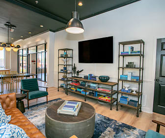 hardwood floored living room featuring TV, Lofts at Riverwalk
