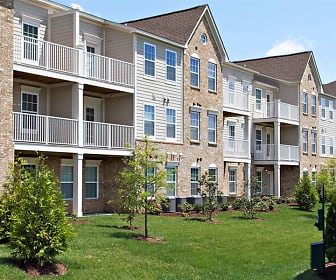 view of building exterior with a lawn, Arbor Brook Apartments