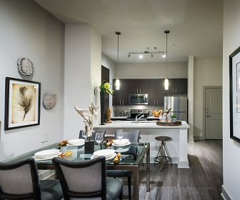 dining area featuring parquet floors, a kitchen breakfast bar, microwave, range oven, and stainless steel refrigerator, The Sylvan