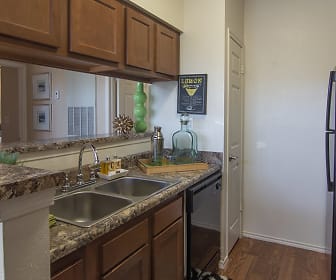kitchen with range oven, refrigerator, dishwasher, dark stone countertops, light parquet floors, and brown cabinetry, Century Lake Apartment Homes