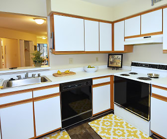 kitchen with dishwasher, ventilation hood, electric range oven, dark flooring, white cabinets, and light countertops, Northampton Apartment Homes