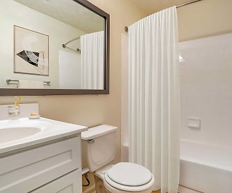 full bathroom featuring vanity, tub / shower combination, toilet, mirror, and shower curtain, eaves Columbia Town Center