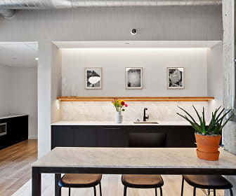 bar with a breakfast bar area, white cabinets, light parquet floors, and light countertops, Hudson Park North