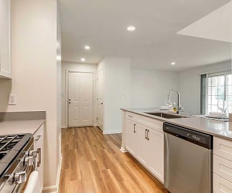 kitchen featuring natural light, microwave, stainless steel dishwasher, light parquet floors, white cabinets, and light countertops, Avalon at The Pinehills