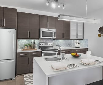 kitchen featuring stainless steel appliances, electric range oven, dark brown cabinets, light countertops, and light flooring, Camden Gallery