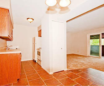 kitchen with natural light, refrigerator, range oven, light countertops, light tile floors, and brown cabinetry, Candlelight Park