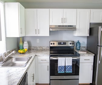 kitchen featuring stainless steel refrigerator, dishwasher, electric range oven, range hood, light countertops, and white cabinetry, Rivers Bend