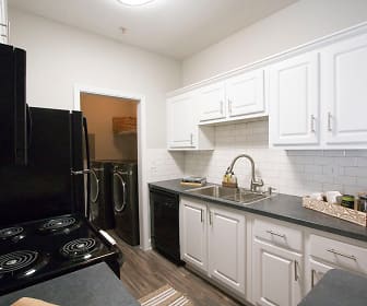 kitchen featuring electric stovetop, washer / dryer, dishwasher, microwave, dark granite-like countertops, white cabinetry, and dark hardwood floors, The Crossing At McDonough