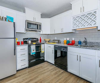 kitchen with stainless steel appliances, range oven, stone countertops, white cabinetry, and light hardwood flooring, Kingston Pointe Apartments