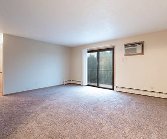empty room featuring carpet, natural light, and baseboard radiator, Sierra Ridge Apartments