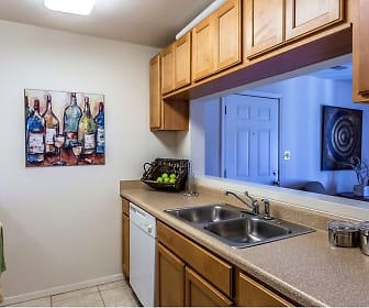 kitchen featuring refrigerator, dishwasher, light countertops, light tile floors, and brown cabinets, Angelo's Grove