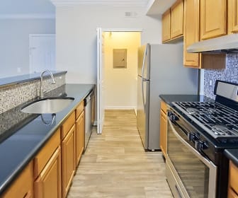 kitchen with ventilation hood, gas range oven, dishwasher, light hardwood floors, and brown cabinets, Bishop's View