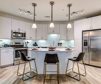 kitchen featuring stainless steel appliances, electric range oven, white cabinetry, pendant lighting, light parquet floors, and light countertops, Celeste at La Cantera