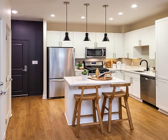 kitchen featuring stainless steel appliances, white cabinetry, light hardwood flooring, pendant lighting, and light countertops, Bell at Courthouse
