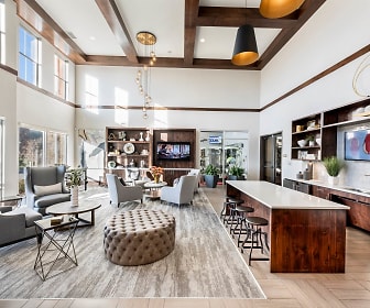 community lobby with parquet floors, natural light, a kitchen bar, beamed ceiling, TV, and dishwasher, Centro