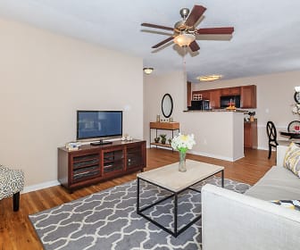 hardwood floored living room with a ceiling fan, TV, and microwave, Trails at Lakeside