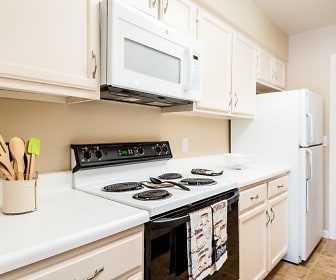 kitchen featuring refrigerator, electric range oven, microwave, light tile floors, white cabinetry, and light countertops, Regency Lakeside Apartment Homes