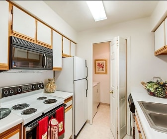 kitchen with refrigerator, electric range oven, dishwasher, microwave, white cabinetry, light countertops, and light tile floors, Woodbury Commons