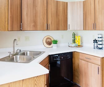 kitchen featuring dishwasher, light countertops, and brown cabinetry, Mequon Trail Townhomes