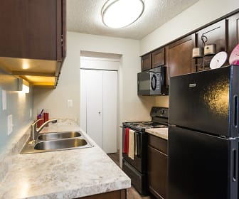 kitchen with refrigerator, electric range oven, microwave, light floors, dark brown cabinetry, and light stone countertops, Park 88
