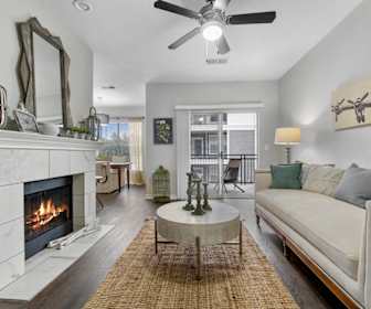 living room featuring hardwood flooring, natural light, a ceiling fan, and a fireplace, Flatiron District at Austin Ranch