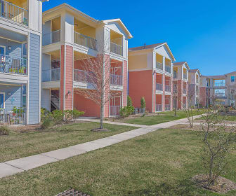 view of property featuring an expansive lawn, Mariposa at Pecan Park 55+ Apartment Homes