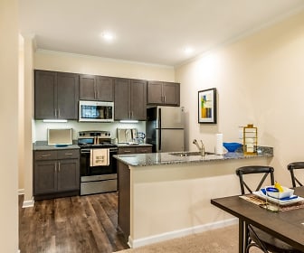 kitchen with stainless steel appliances, range oven, dark hardwood flooring, dark granite-like countertops, and dark brown cabinetry, Ardmore at the Trail