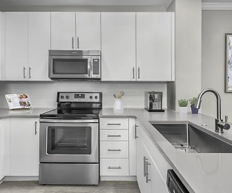 kitchen featuring electric range oven, stainless steel appliances, light floors, white cabinets, and light granite-like countertops, Camden South End