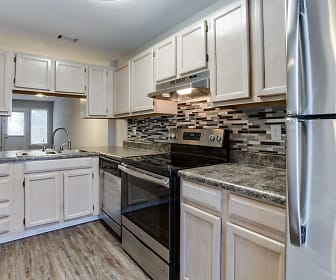 kitchen featuring electric range oven, stainless steel refrigerator, ventilation hood, dishwasher, white cabinetry, dark granite-like countertops, and light parquet floors, The Lory of Augusta