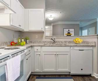 kitchen featuring ventilation hood, electric range oven, dishwasher, dark flooring, and white cabinetry, Wellington Ridge