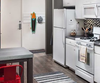 kitchen with microwave, refrigerator, gas range oven, dishwasher, dark countertops, white cabinets, and dark hardwood floors, AVA Somerville