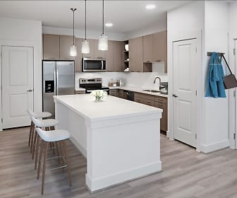 kitchen with a center island, stainless steel appliances, range oven, light brown cabinetry, light hardwood floors, light countertops, and pendant lighting, Camden Cypress Creek